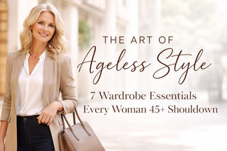 Confident woman in her 50s wearing a beige blazer and white blouse, holding a structured leather handbag, with blog title about ageless style overlaid on a soft city background