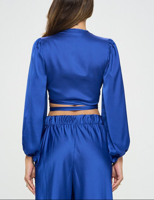 Blue satin outfit with long sleeves on a white background