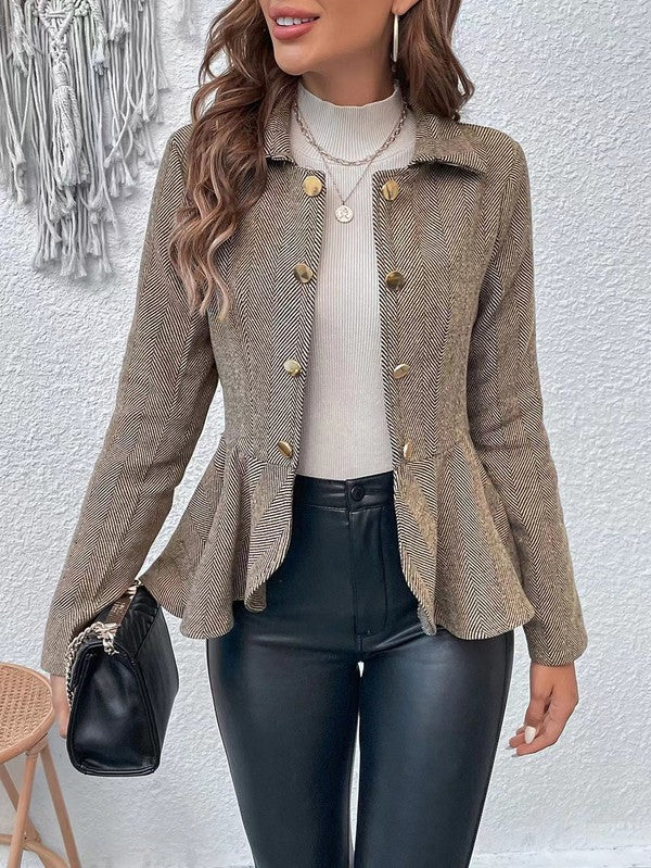 Woman wearing a beige textured jacket with gold buttons against a white wall.