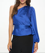 Woman wearing a blue one-shoulder top with a white background