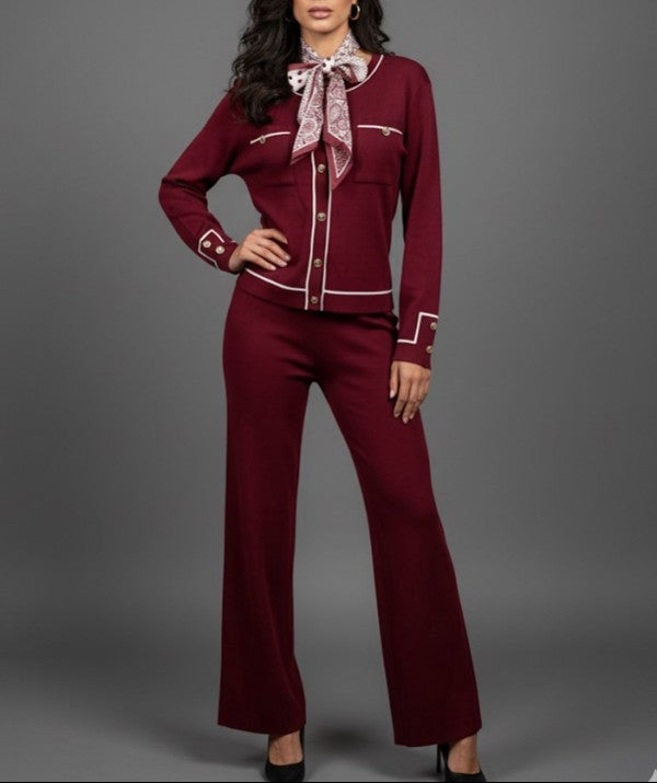 Woman wearing a burgundy outfit with a matching scarf on a gray background